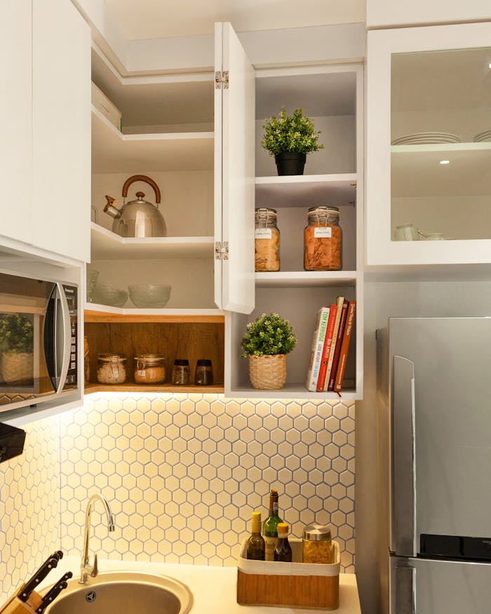 about-03 Stylish kitchen interior with open shelves, plants, and utensils.